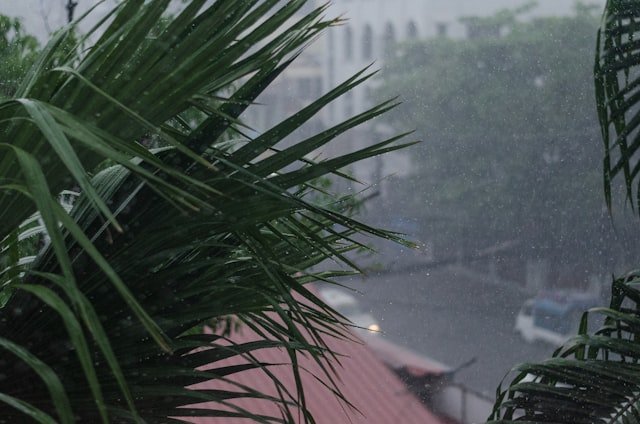 a view of a building through a window in the rain
