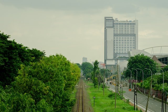 a view of a train track and a building in the background